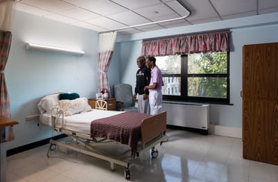 Two residents interacting in a well-lit room