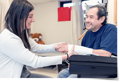 Therapist assisting a resident with a bandaged hand