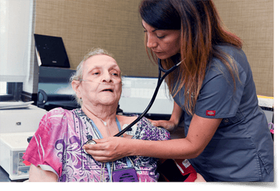 Nurse attending to an elderly resident in a care setting