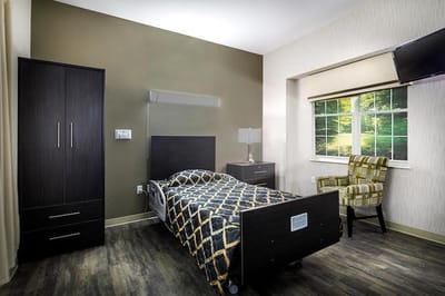 Private resident room with bed and chair