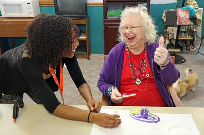 Staff and resident enjoying a creative activity together