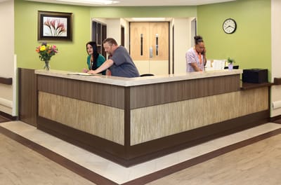 Reception area with staff assisting residents