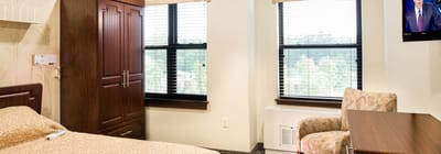 Private resident room with bed and TV