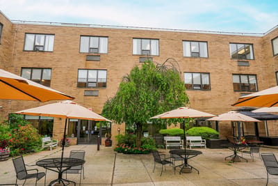 Outdoor patio area with tables and umbrellas