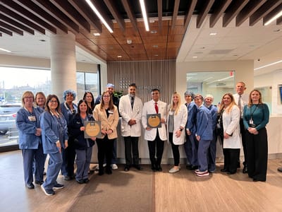 Group of staff members posing in a facility lobby