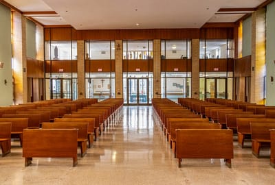 Interior view of a chapel with wooden pews
