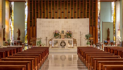 Interior view of a chapel with wooden pews