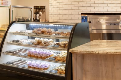 Bakery display case with assorted pastries and desserts