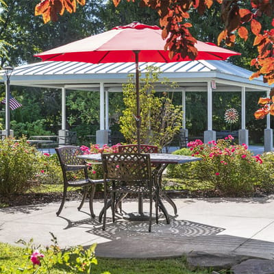 Outdoor seating area with a red umbrella