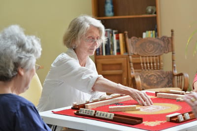 Residents engaged in a game of Mahjong