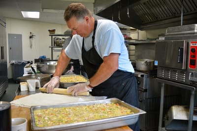 Staff member preparing food in a kitchen