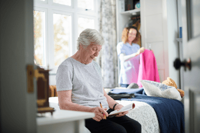 Resident engaging in an activity while staff assists