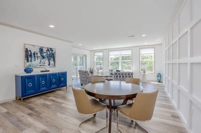 Bright common area with a dining table and artwork