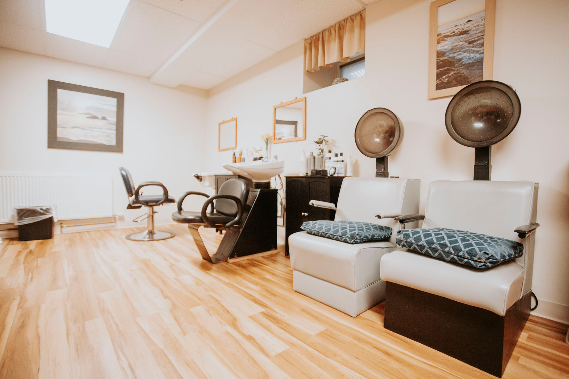 Salon area with chairs and hairdryer stations