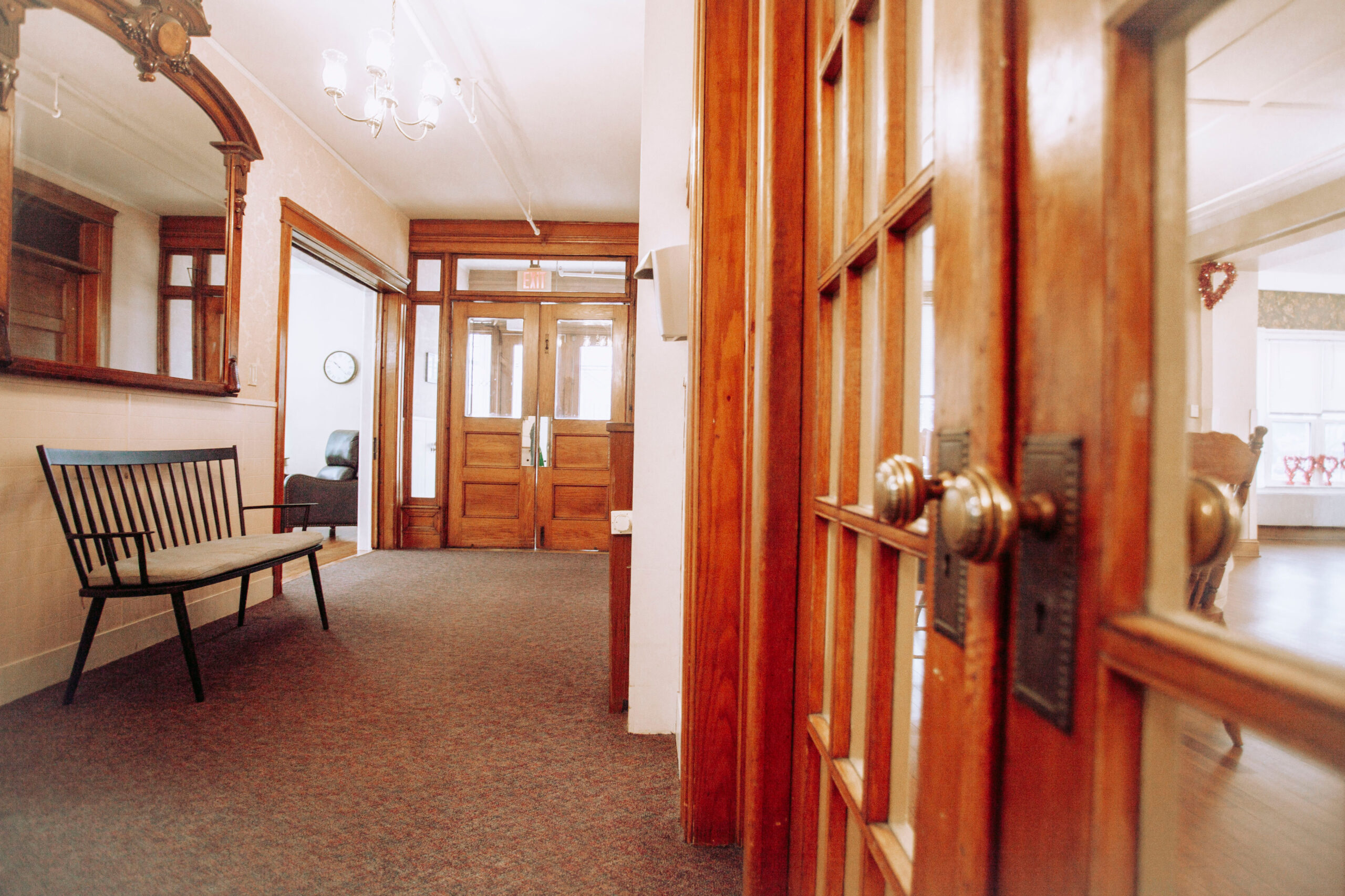 Hallway with a bench and wooden doors