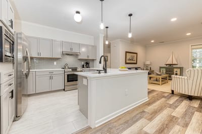 Bright kitchen and living area in a senior living unit