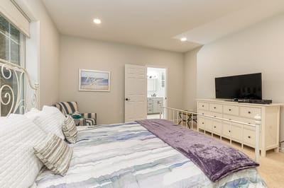 A cozy interior of a resident room with a bed and TV