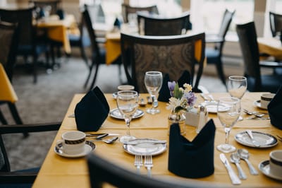 A beautifully set dining table in the facility's dining room