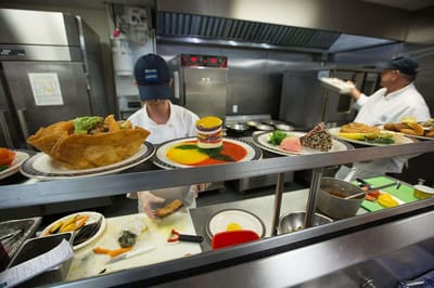 Staff preparing meals in a bustling kitchen