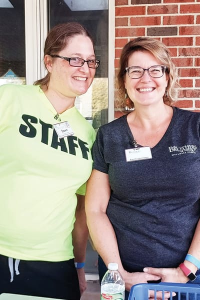 Staff members smiling at an outdoor event