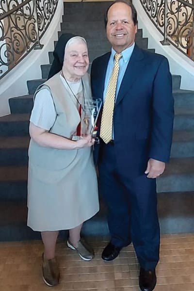 Award presentation involving a resident and staff member