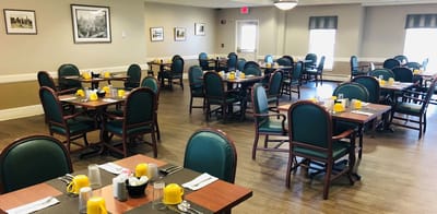 Bright dining room with tables set for meals