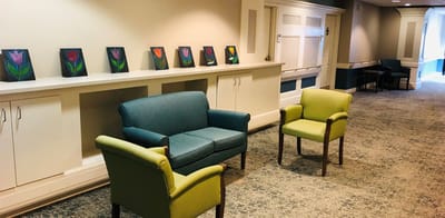 Bright interior common area with seating and artwork