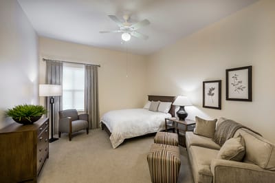 Cozy private resident room with bed and seating area