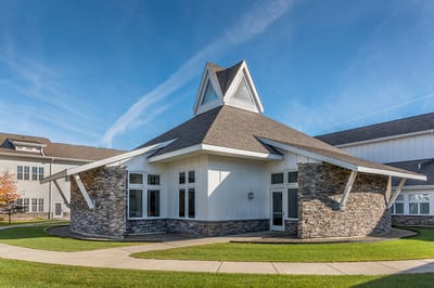 Building exterior of St. Francis Park with landscaping
