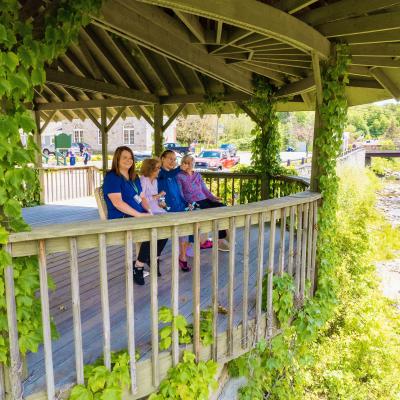 Residents and staff relaxing in a gazebo