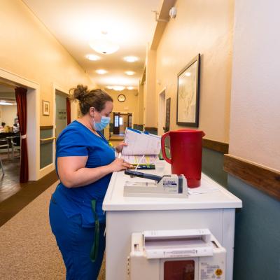 Staff member organizing materials in a hallway