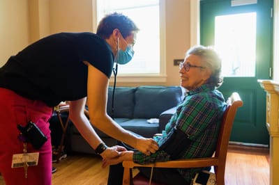 Healthcare staff checking a resident's blood pressure
