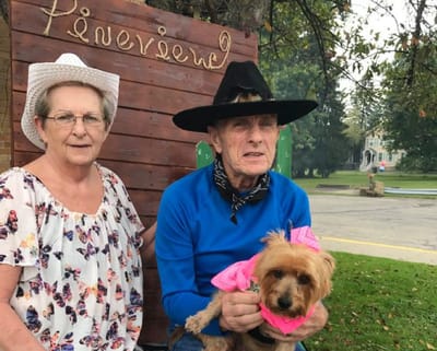 Residents enjoying an outdoor event with a dog