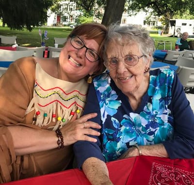 Smiling staff member and resident at an outdoor event