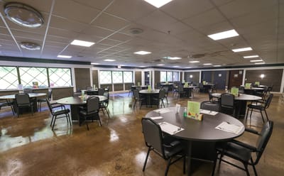 Dining area with tables and chairs arranged for meals