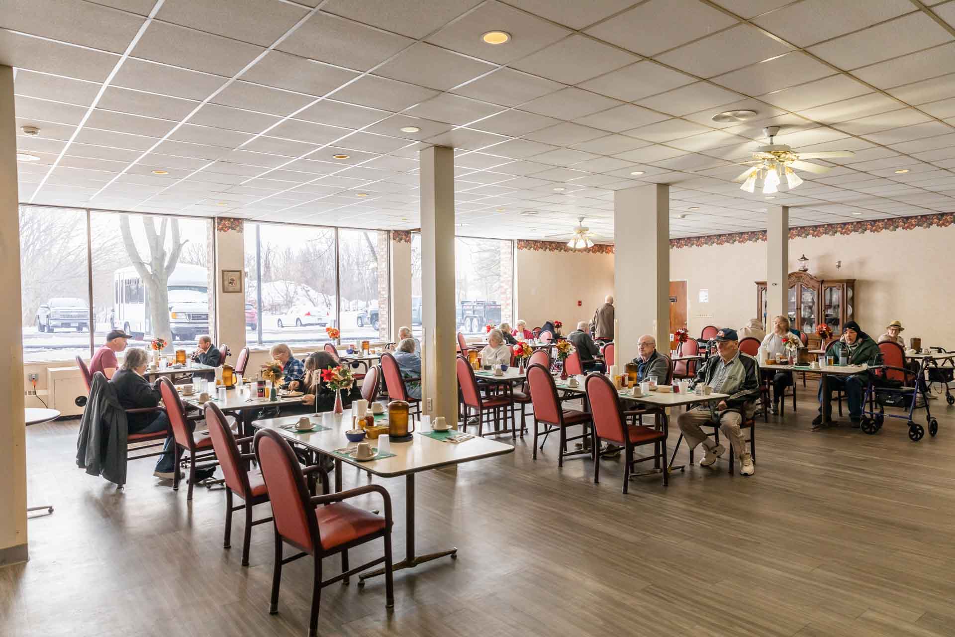 Residents enjoying meals in a bright dining room