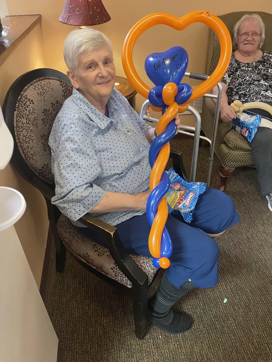 Residents engaged in a craft activity with balloon art