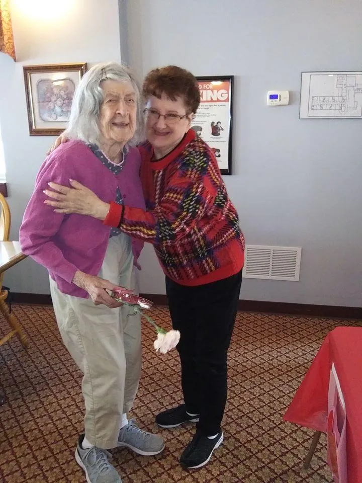 Two residents smiling together in a common area