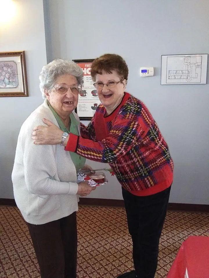 Two residents enjoying a moment together in the facility