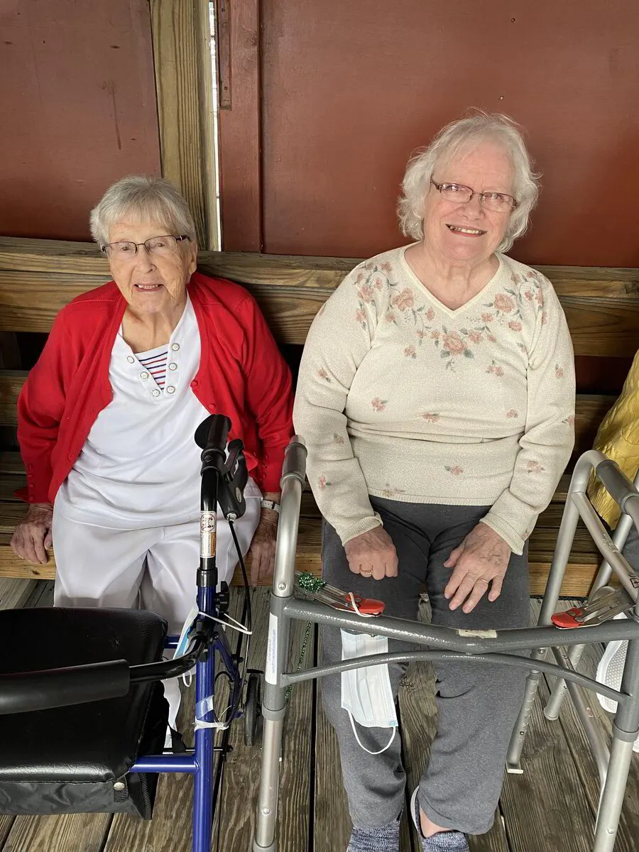 Two elderly women sitting on a porch