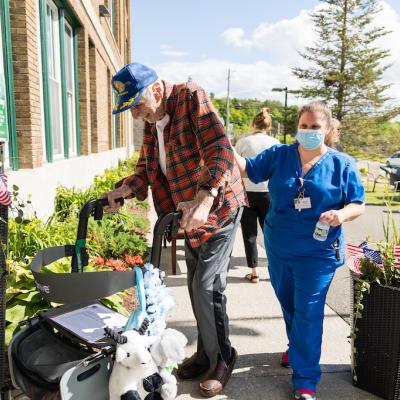 Resident assisted by staff member outside