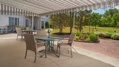Patio area with tables and chairs under an awning