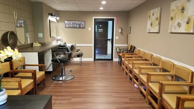 Beauty salon area with chairs and mirrors