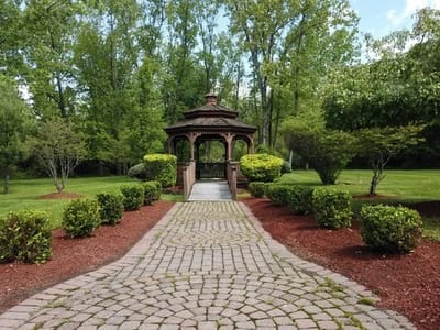 A pathway leading to a gazebo in a landscaped area
