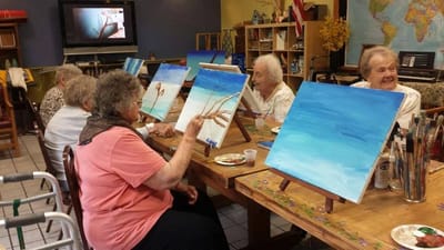 Residents participating in a painting class