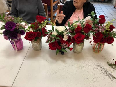 Residents creating flower arrangements during an activity