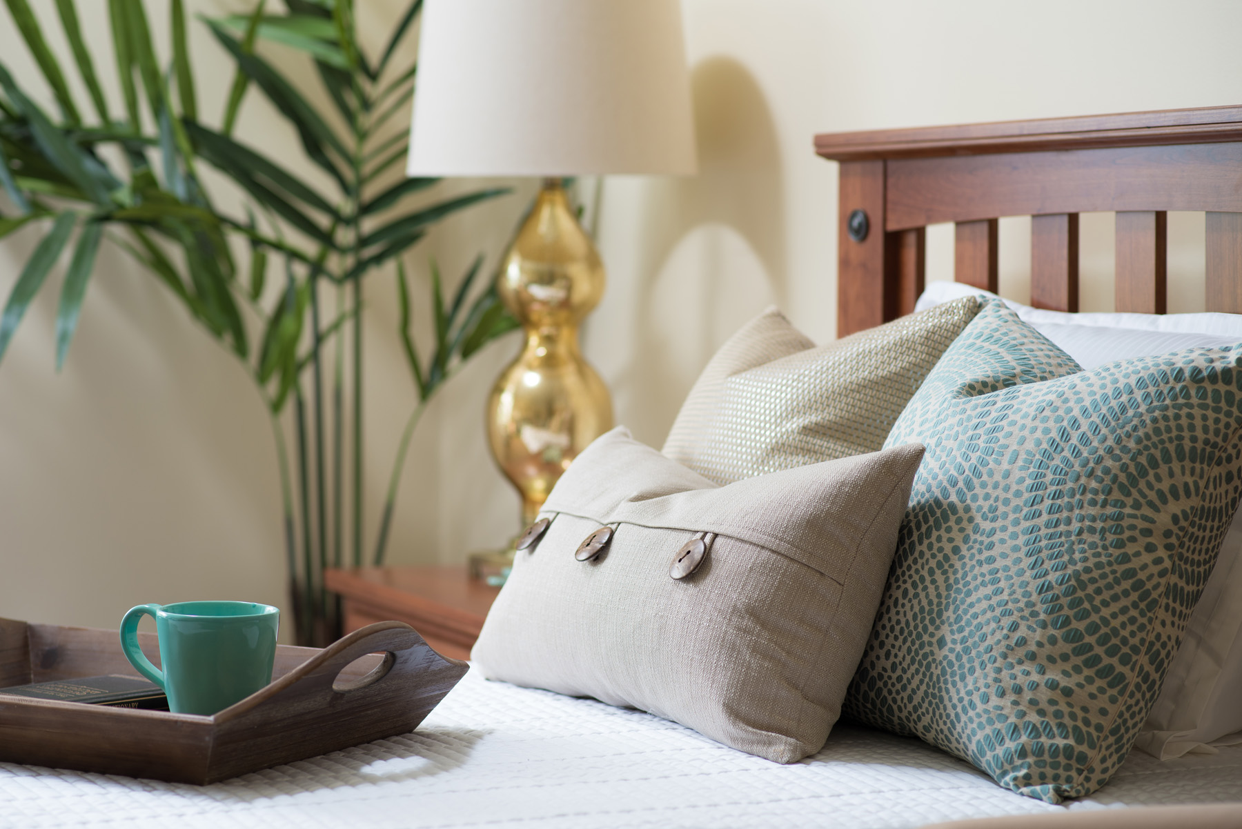 Decorative pillows on a neatly made bed in a room
