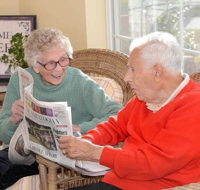 Residents enjoying a reading activity together