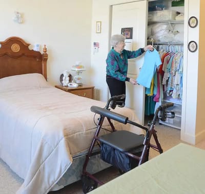 Resident arranging clothes in a private room