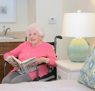 Resident enjoying a book in a cozy room